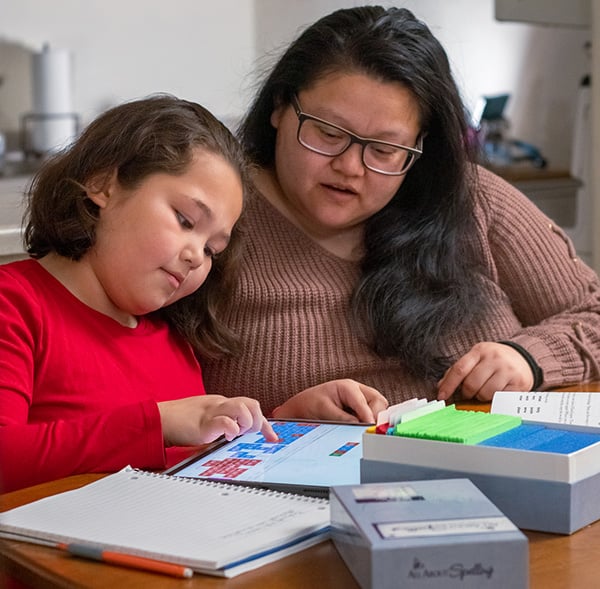 A mother and daughter working on All About Spelling